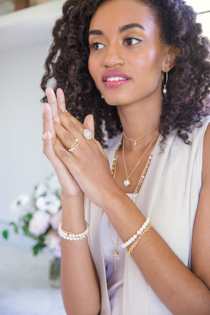 women with layered necklaces and rings